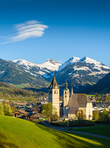 The austrian City Kitzbühel with a snow covered mountain range in the background