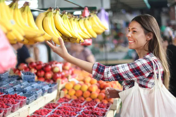 Photo of Woman choosing bananas