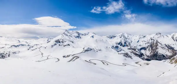 Panoramic view of a high alpine road in Austria surrounded from snow in spring.