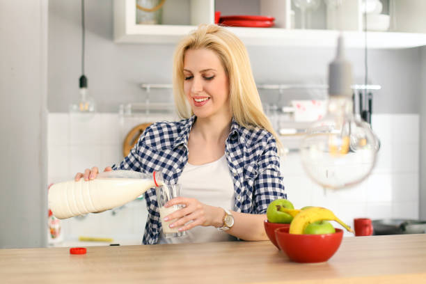 istock Young beautiful woman drinking milk 816314332