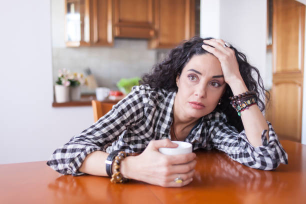 istock Young woman drinking coffee at home 816317398