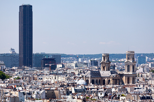 Paris, France - July 07 2017: Cityscape of Paris with the Église Saint-Sulpice in the foreground and the Tour Montparnasse in the background.