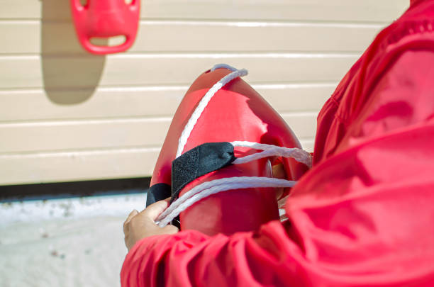 istock Lifeguard on duty float lifesaver equipment in hand 816336394