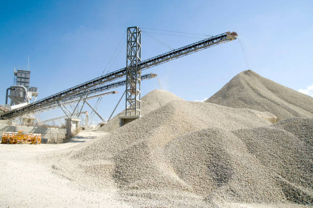 several working belt conveyors and a piles of rubble in gravel quarry - quarry imagens e fotografias de stock