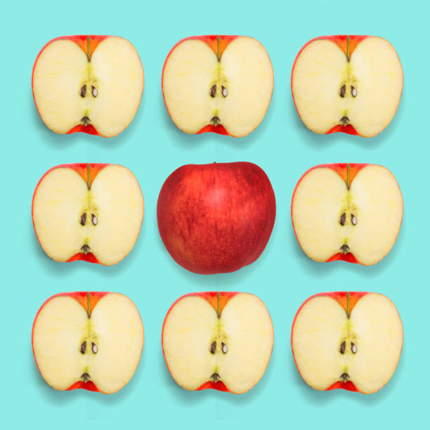 istock Half apples with middle apple on blue background. Minimal concept. Pop color. Top view. 816354140