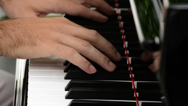 Hands playing piano close up