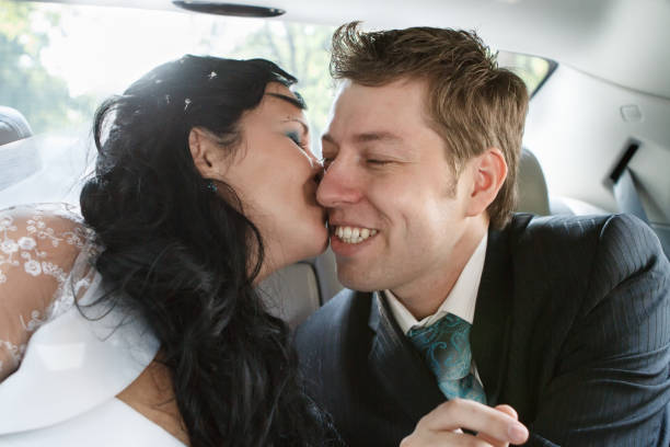 istock Groom and bride in the wedding car 816386872