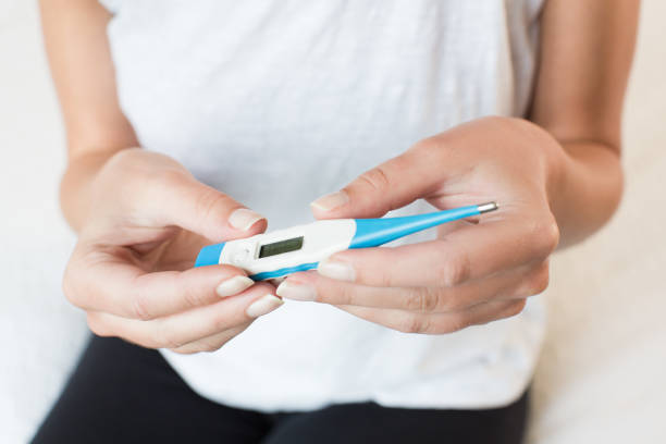 istock Sick woman measuring body temperature 816394496