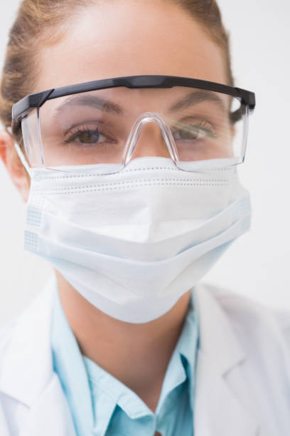 istock Dentist with surgical mask and protective glasses 816402456