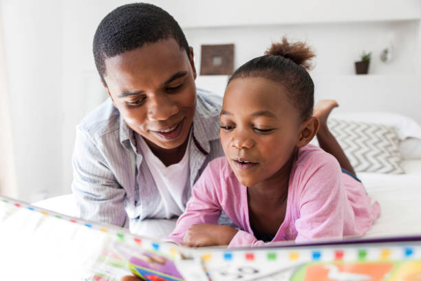 istock Father listening to his daughter read. 816420924