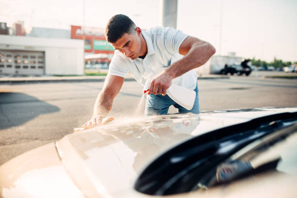 istock Man rubbing vehicle with car polish 816443484