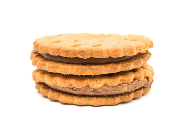 Sandwich cookies with chocolate cream on a white background