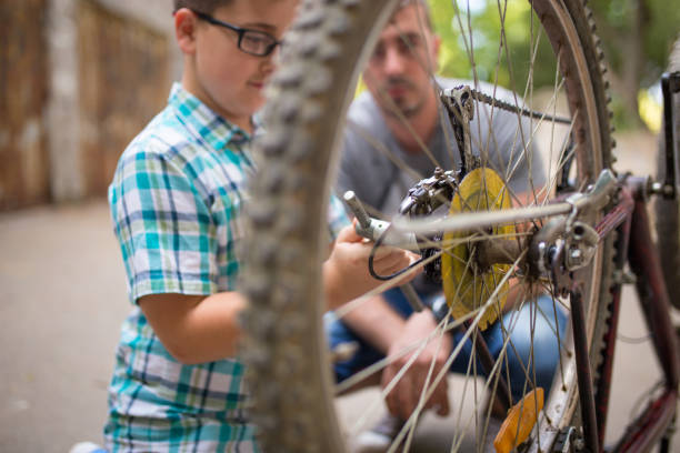 istock Father and son repairing bike 816461400