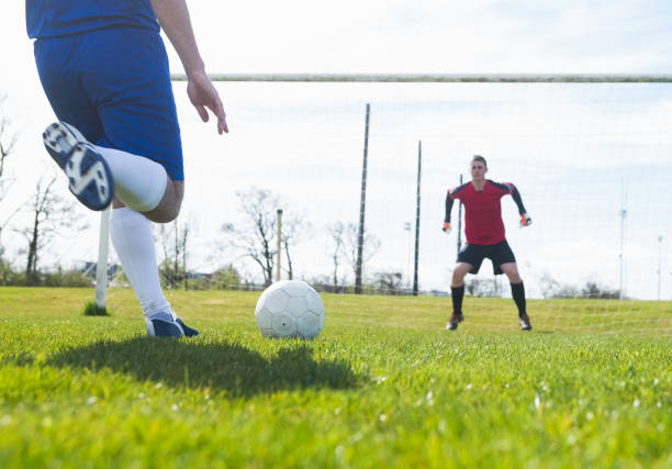 istock Goalkeeper in red ready to save a penalty 816476928
