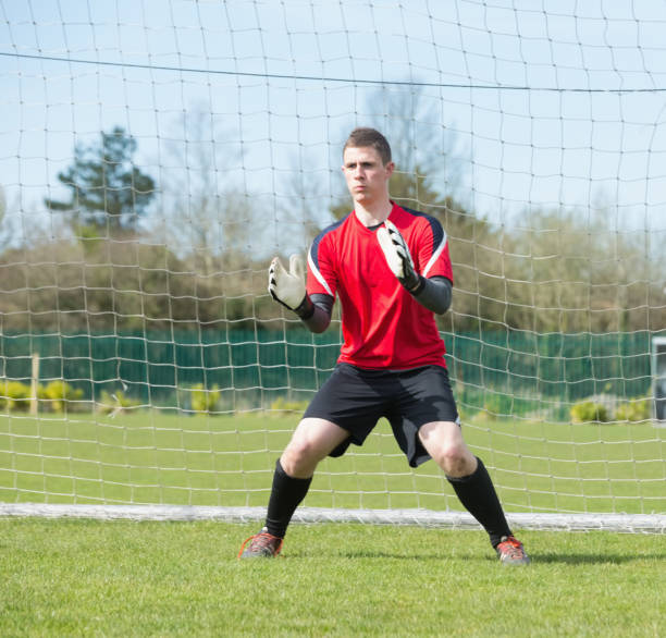 istock Goalkeeper in red ready to make a save 816476994