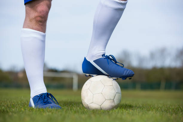 istock Football player standing with the ball 816477270