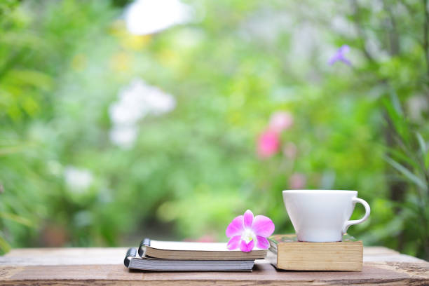 istock Butterfly Tree flower and books with tea cup 816493414