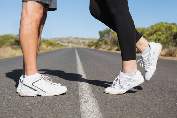 istock Fit couple standing on the open road together 816504648