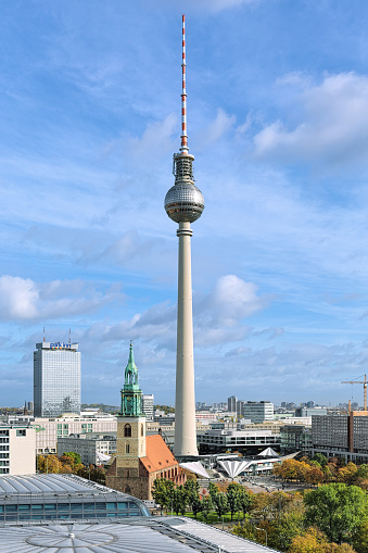 Berlin, Germany - October 29, 2016: Fernsehturm TV Tower with height of 368 meters and St. Mary's Church of the 13th century. Aerial view from the viewing gallery around the dome of Berlin Cathedral.