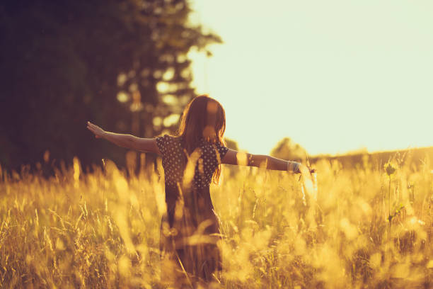 women in the evening sky in a meadow