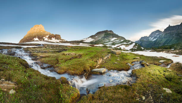 Reynolds Mountain at Logan Pass, Glacier National Park Montana - Western USA, Field, Meadow, River, Springtime snow river stock pictures, royalty-free photos & images