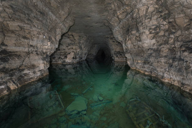 underground lake in an ancient gypsum quarry collapsing - building exterior obsolete abandoned damaged imagens e fotografias de stock