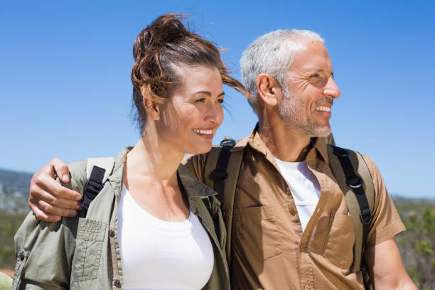 istock Hiking couple smiling together on mountain trail 816568616