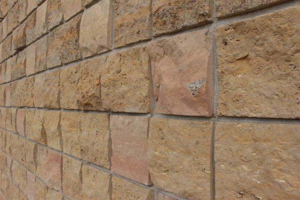 istock Closeup Angled View of Square Limestone Brick Wall 816580788
