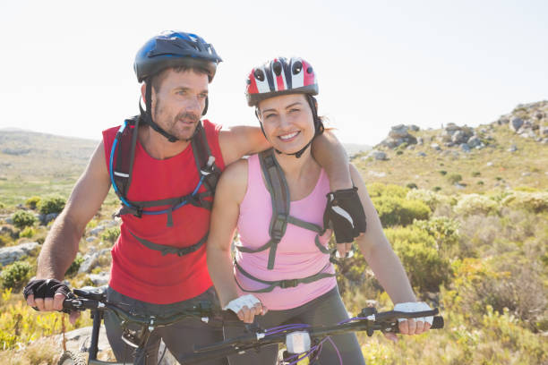istock Fit cyclist couple smiling together on mountain trail 816610534