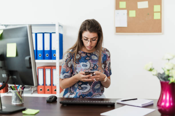 istock Businesswoman typing a message on her phone 816619344