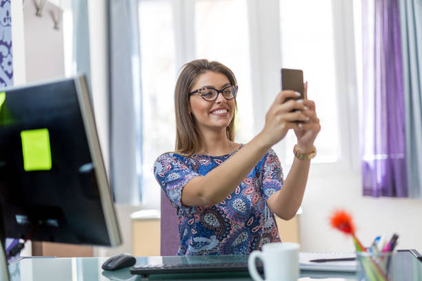 istock Businesswoman taking a selfie in her office 816628246