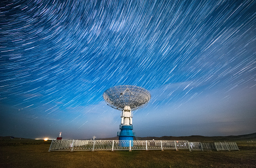 Satellite dish under a starry sky