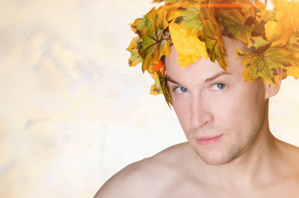 istock Autumn. A handsome man and orange foliage. Day. The sun. 816638552