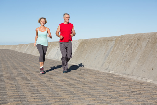 Active senior couple out for a jog on a sunny day