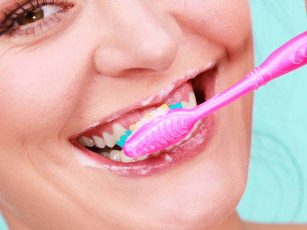 istock Woman brushing cleaning teeth 816675020