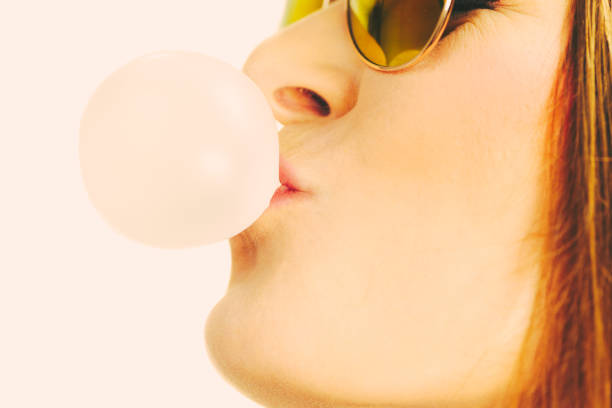 istock Funky girl blowing balloon. 816679590