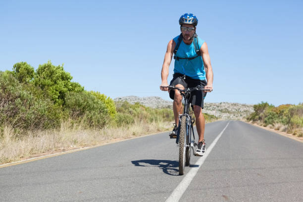 istock Athletic man cycling on open road 816682142