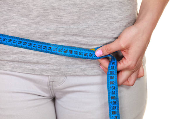 istock Woman measuring her hips closeup 816686774