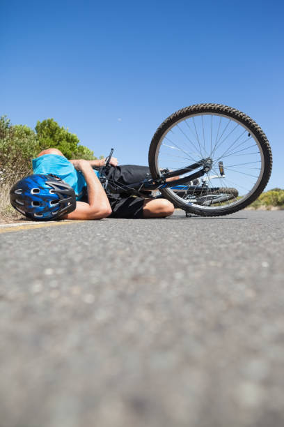 istock Cyclist lying on the road after an accident 816686828