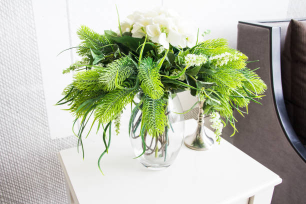 istock Decoration artificial flower in jar on wood table 816687438
