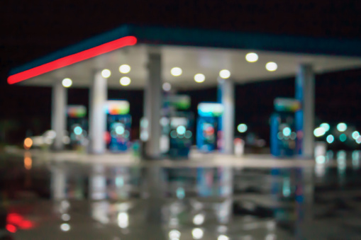 blur image of gas station at night