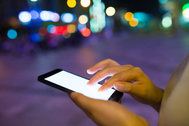 istock Close-up man with smart phone at night 816696942