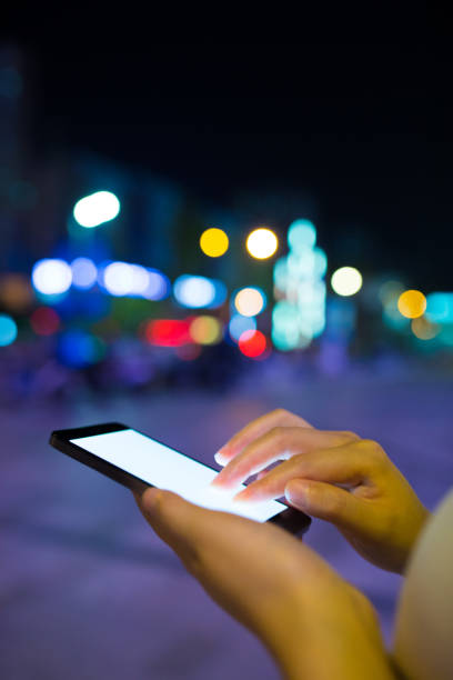 istock Close-up man with smart phone at night 816696962
