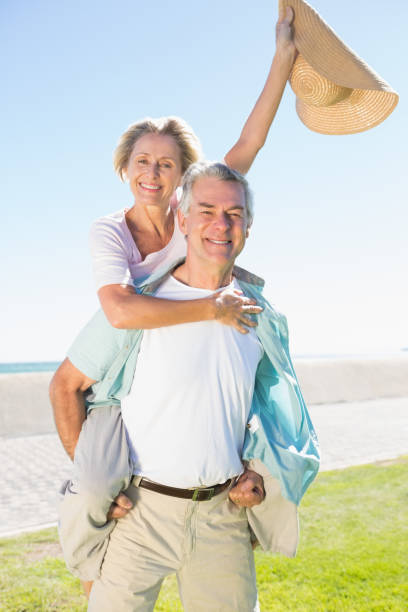 istock Happy senior man giving his partner a piggy back 816697014