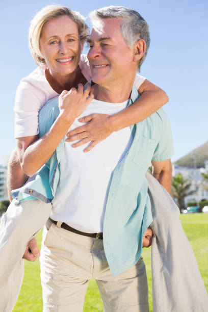 istock Happy senior man giving his partner a piggy back 816701478