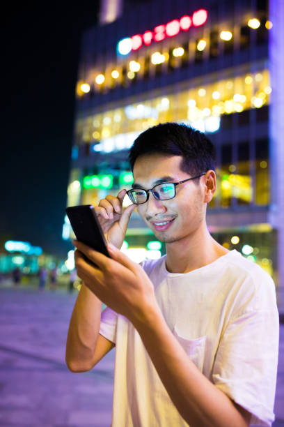 istock Close-up man with smart phone at night 816701576