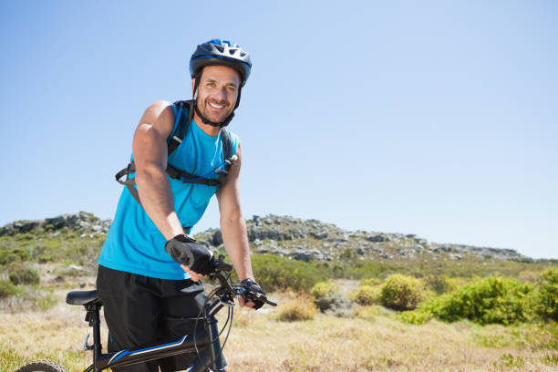 istock Fit cyclist riding in the countryside smiling at camera 816701672