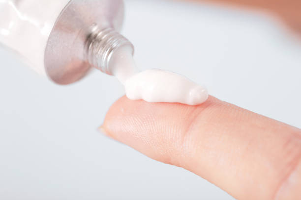 Cream tube Close up image of hands with cream tube ointment photos stock pictures, royalty-free photos & images