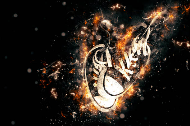 istock Sneakers on fire isolated in black background. 816726182