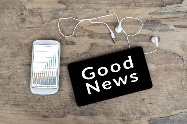 istock Good News on tablet pc screen with smart phone. 816726238